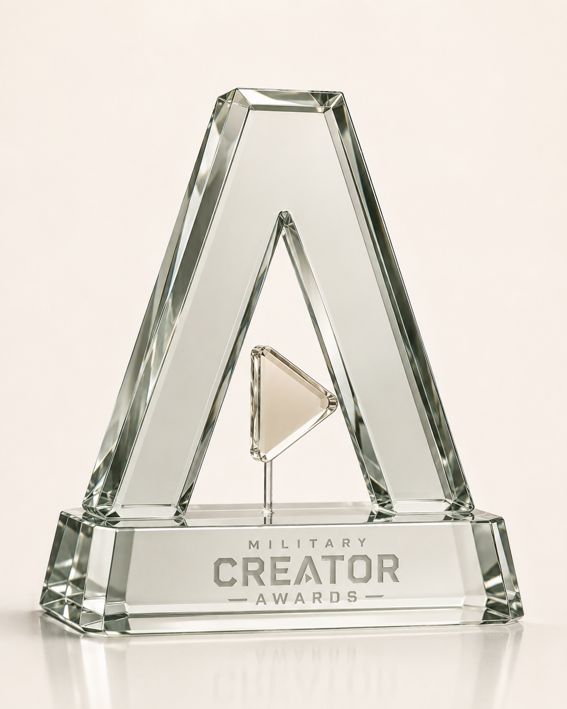 The Military Creator Awards trophy — a crystal A with a brass play-button triangle