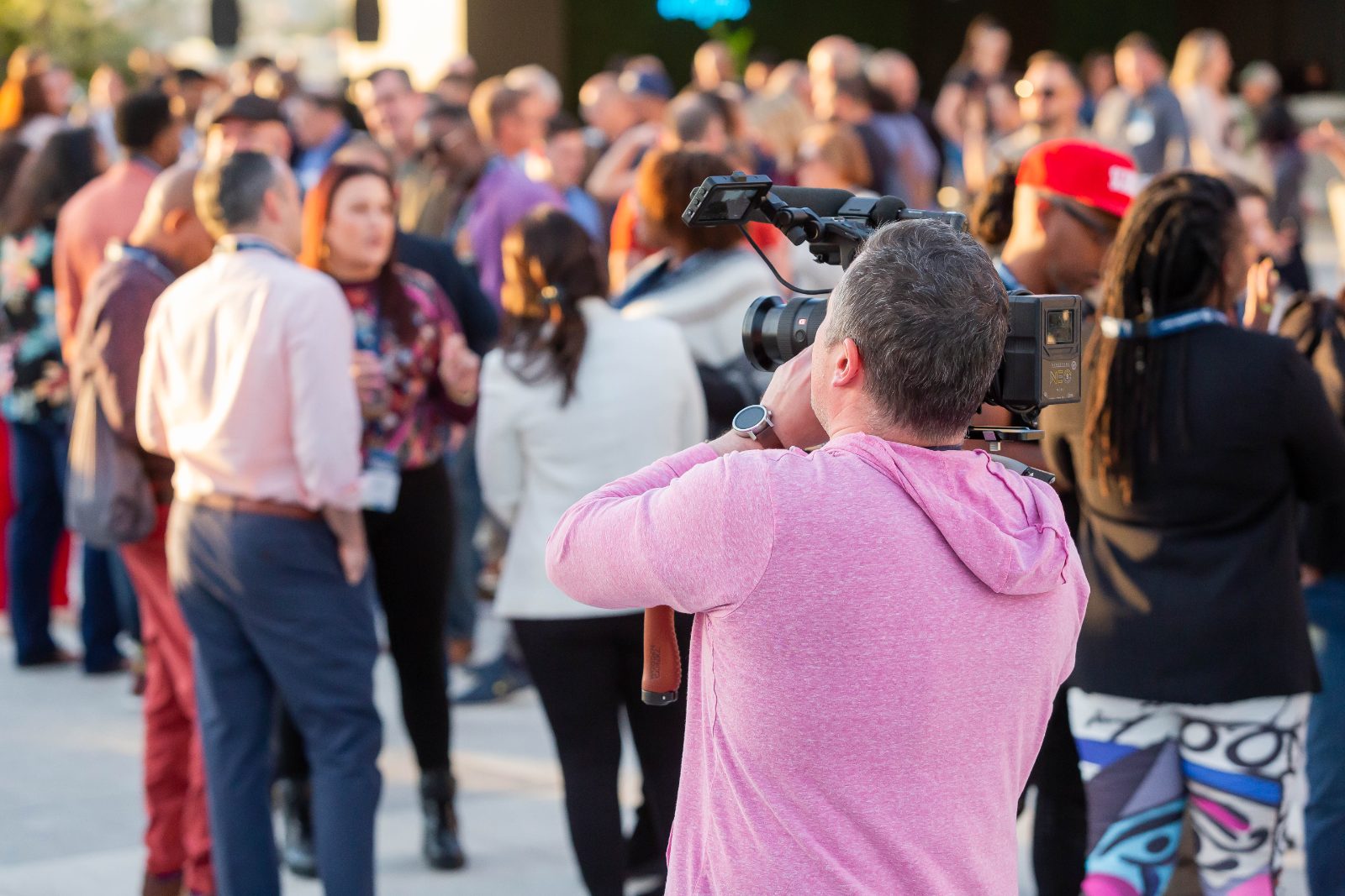 Videographer filming a community gathering